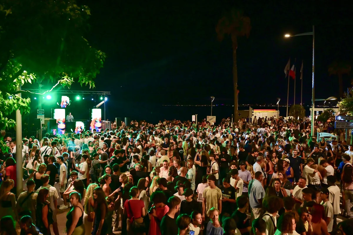 Public dense devant la scène éclairée en vert, de nuit, à la Nuit des DJ de Cagnes-sur-Mer